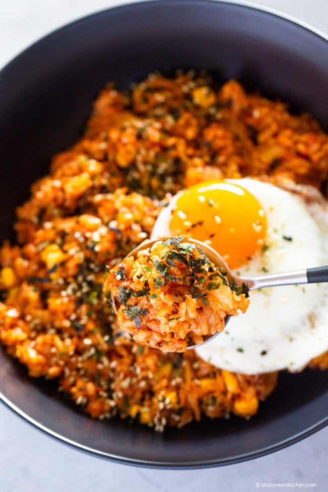 A close-up photo of tuna kimchi fried rice, heaped on a spoon.