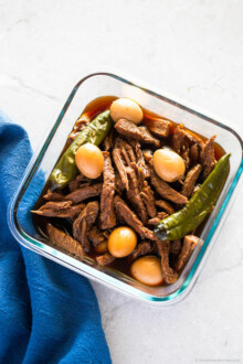 Finished Jangjorim, soy braised beef and quail eggs, in a glass container.