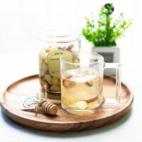 Front shot of Korean gingseng tea served on a wooden tray.