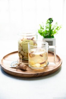 Front shot of Korean gingseng tea served on a wooden tray.