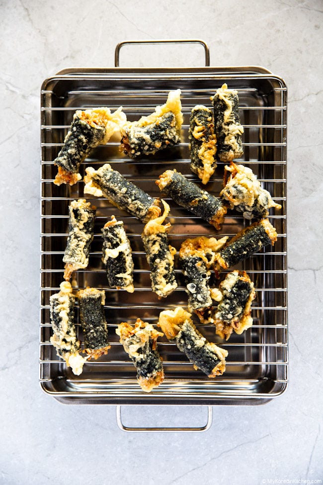 Gimmari placed on a grill rack over a tray.