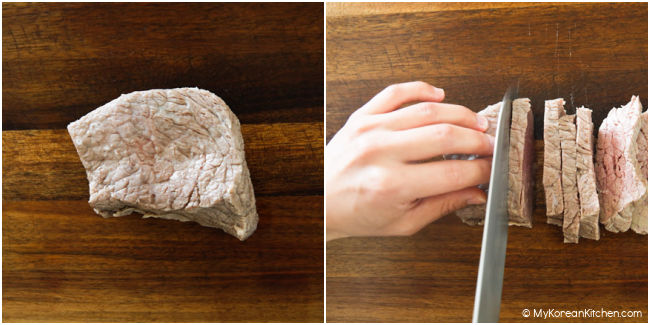 Slicing beef on a wooden cutting board.