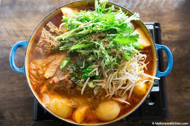 Boiling Gamjatang (Korean Pork Bone Soup) on gas bunner