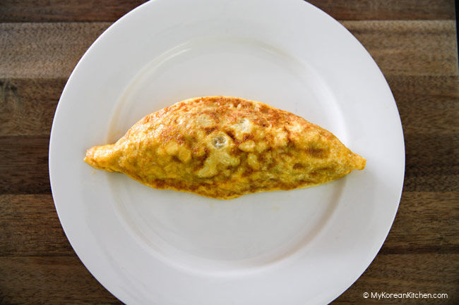 Oval shaped omurice on a white plate