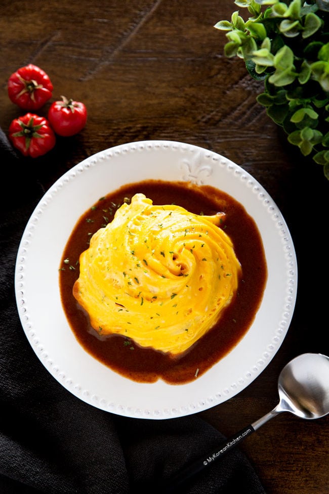 Tornado omurice (Korean omelette rice) served on a white plate