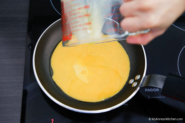 Pouring beaten egg
