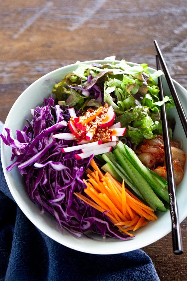 Korean noodle salad topped with spicy gochujang sauce