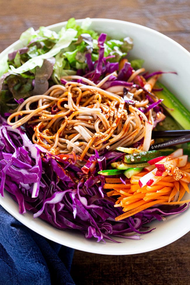 Mixing bibim guksu with chopsticks