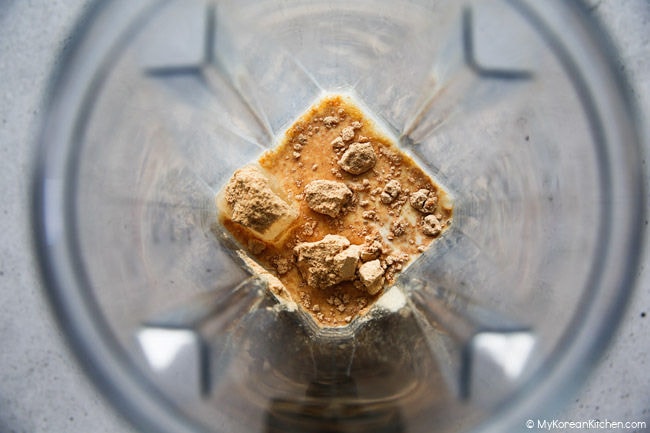 Ingredients for a misugaru latte are placed in a blender before being blended.
