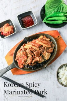 Korean Spicy Marinated Pork (Jeyuk Bokkeum) served on a BBQ grill plate with ssam ingredients.