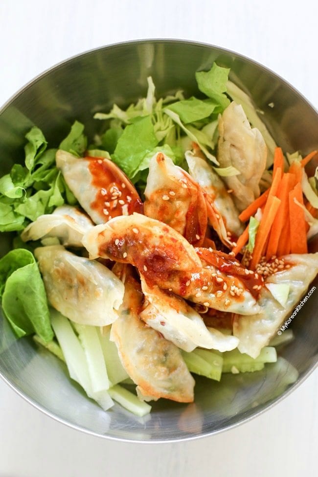 Bibim mandu ingredients ready to be mixed in a bowl.