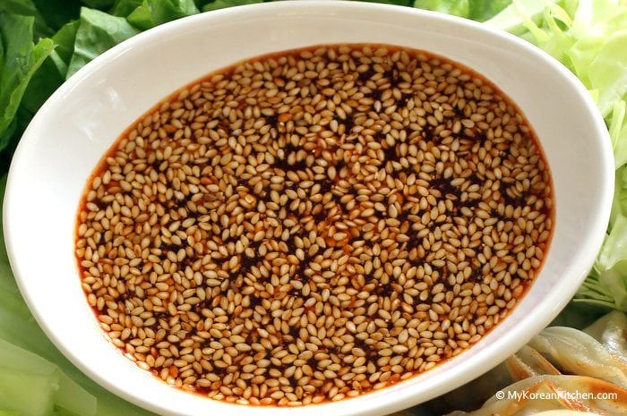 Dumpling salad dressing in a white oval bowl.