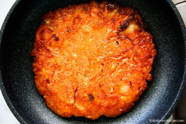Freshly cooked crispy kimchi pancake resting in the pan
