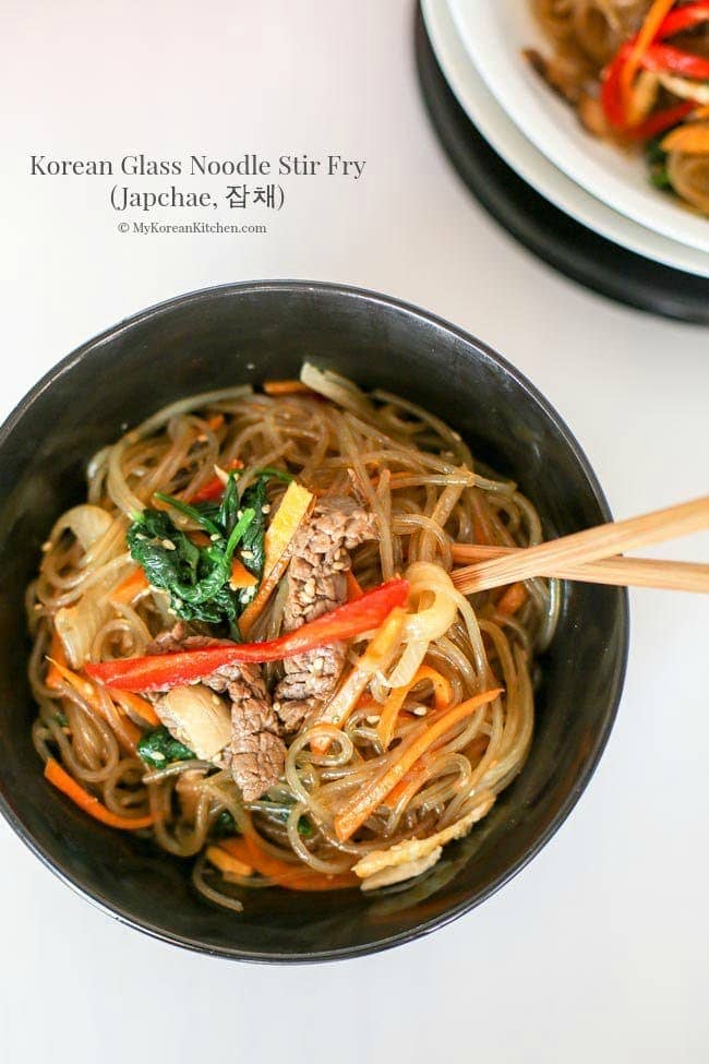 Japchae in a black bowl