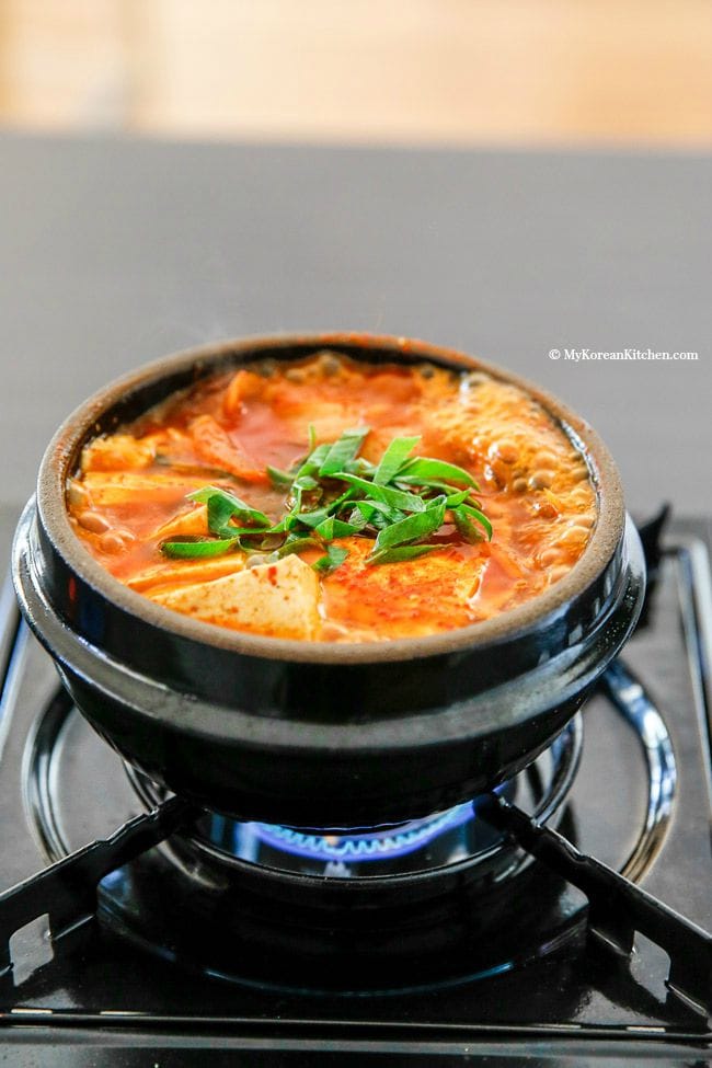 The classic Kimchi Jjigae (Kimchi stew) recipe with some fatty pork. When the fat from the pork melts into the soup, it becomes irresistibly delicious! | MyKoreanKitchen.com