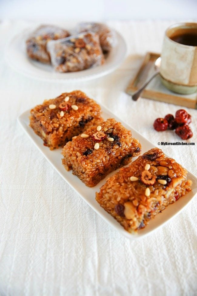 Close up photo of Yaksik dessert elegantly served on a rectangular white plate.