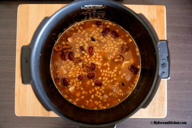 Yaksik ingredients filled in a rice cooker pot and ready to cook.