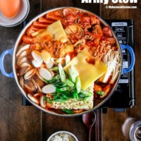 Korean army stew (Budae Jjigae) is a Korean fusion hot pot dish loaded with Kimchi, spam, sausages, mushrooms, instant ramen noodles and cheese. The soup is so comforting and addictive! | MyKoreanKitchen.com