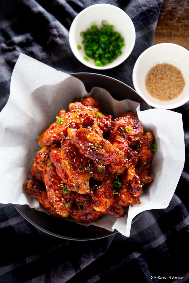 Korean chicken wings garnished with chopped green onions and sesame seeds