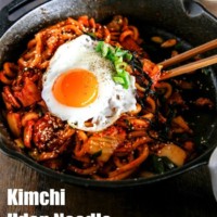 Kimchi udon noodle stir fry is an easy weeknight meal that can be ready in 15 mins. Key ingredients are bacon, Kimchi, udon noodles and Korean spicy sauce. It's simply addictive! It will be your new favourite noodle dish! | MyKoreanKitchen.com