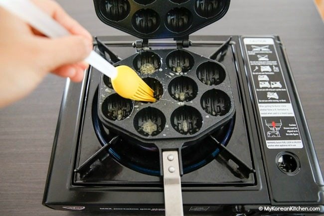 Brushing butter on walnut cake mold
