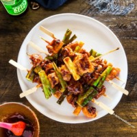 Chicken skewers stacked on a place