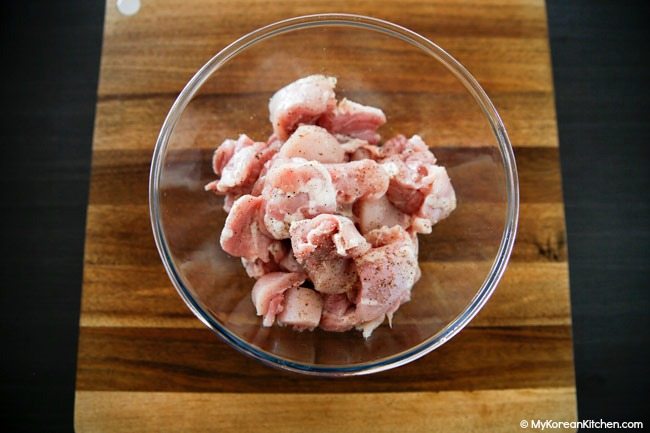 Seasoned chicken pieces in a bowl