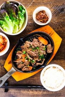 Bulgogi served with rice, lettuce, kimchi and dipping sauce