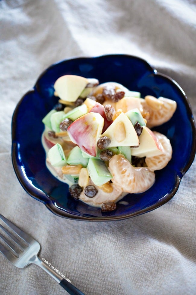 Creamy fruit salad on a blue plate