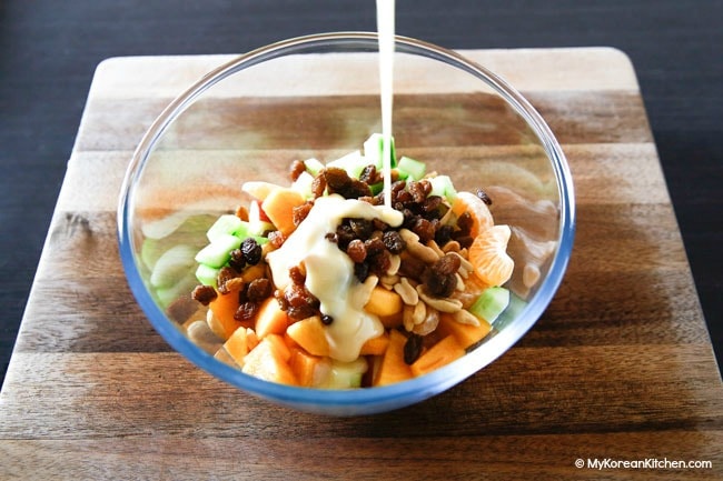 Creamy fruit salad in a glass bowl
