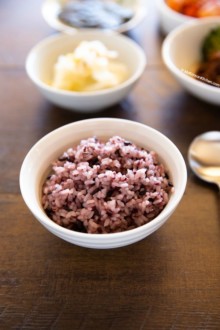 Purple rice served in white bowl