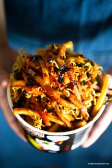 Holding a cup of fire noodle fries