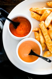 close up photo of spicy gochujang mayo and spicy sriracha mayo served with chips