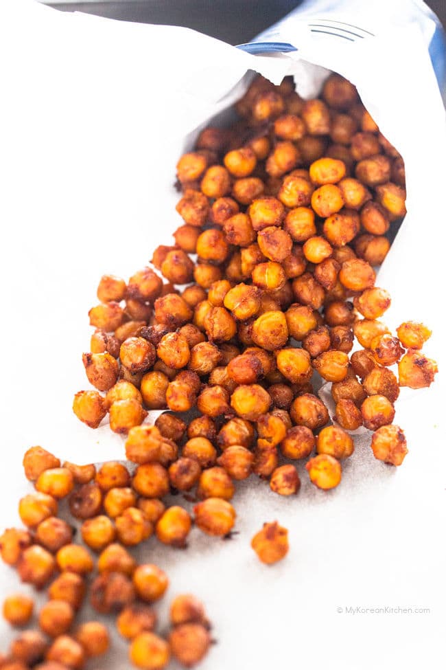 Roasted chickpeas pouring out from a mini bucket