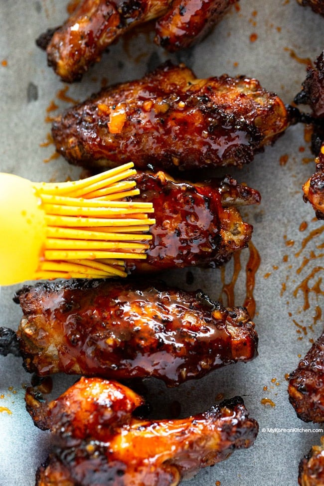 Basting the sauce over chicken wings