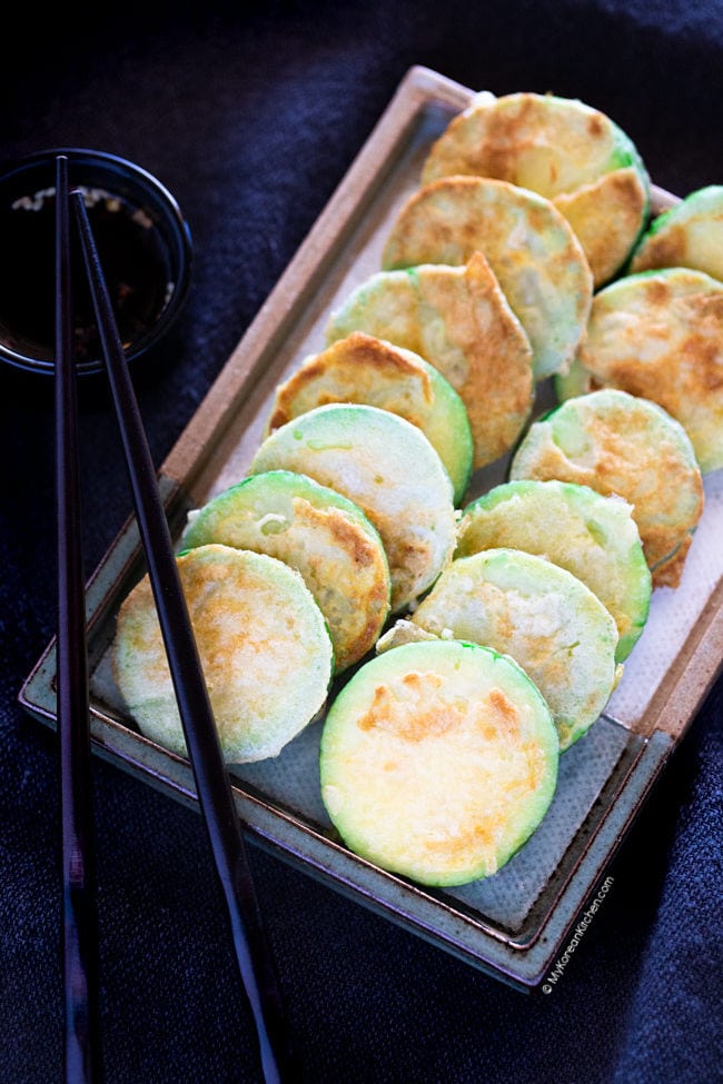 Pan fried zucchini served on a rectangular plate