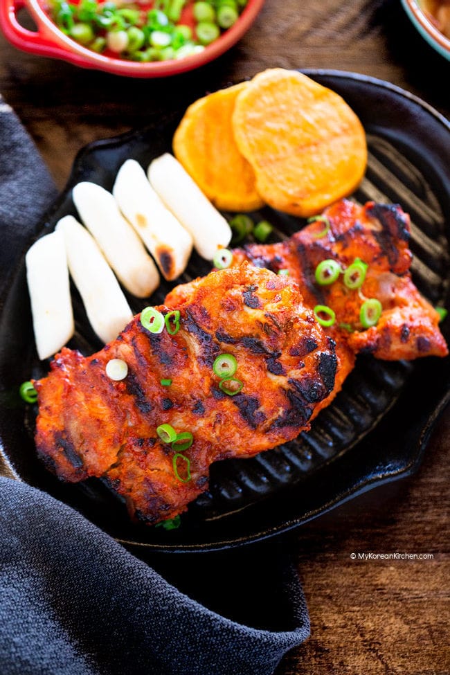grilled chicken, rice cakes, sweet potatoes on a black grill plate