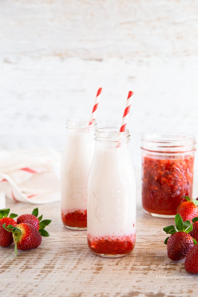 two bottles of strawberry milk with straws