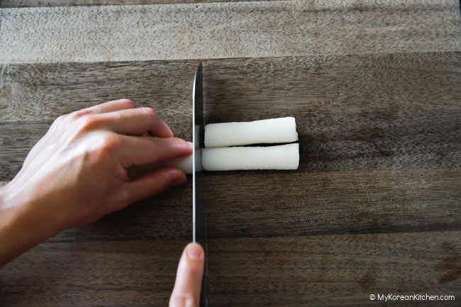 slicing rice cakes into little finger sized pieces