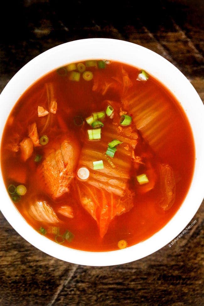 Kimchi soup served in a white soup bowl