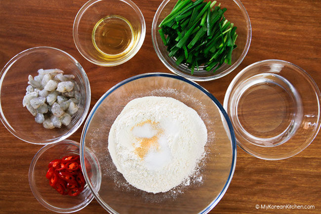Chive pancake ingredients arranged on wooden board