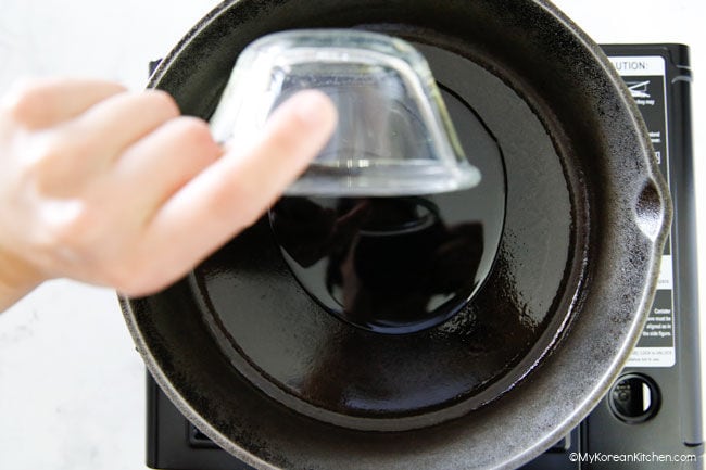 Pouring cooking oil in skillet