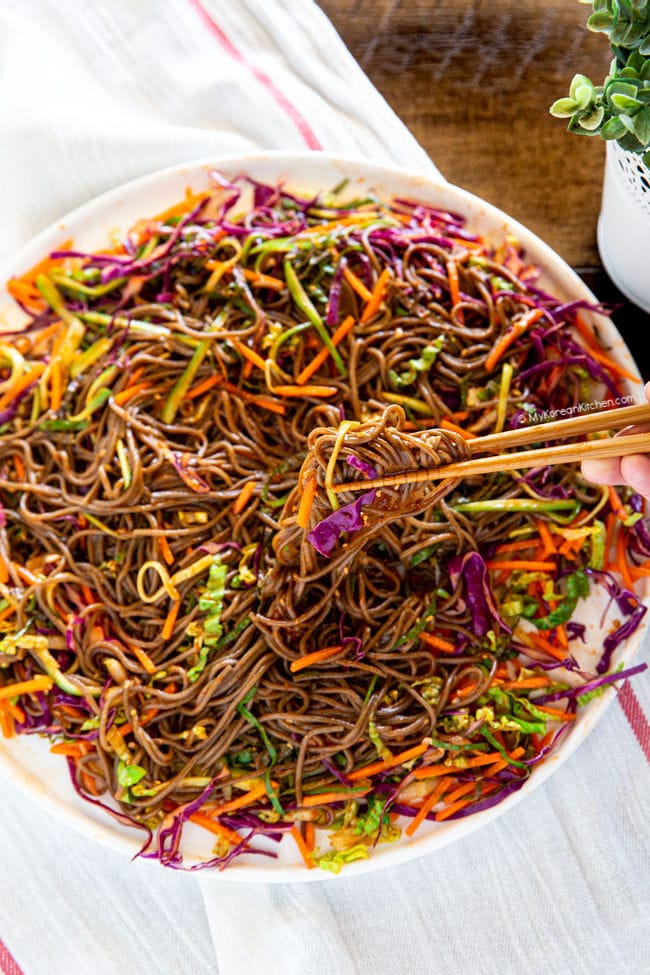 holding mixed noodles with chopsticks