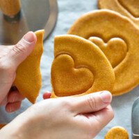 breaking dalgona while reserving the love heart shape