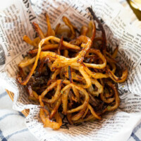 honey butter squid jerky served on parchment paper