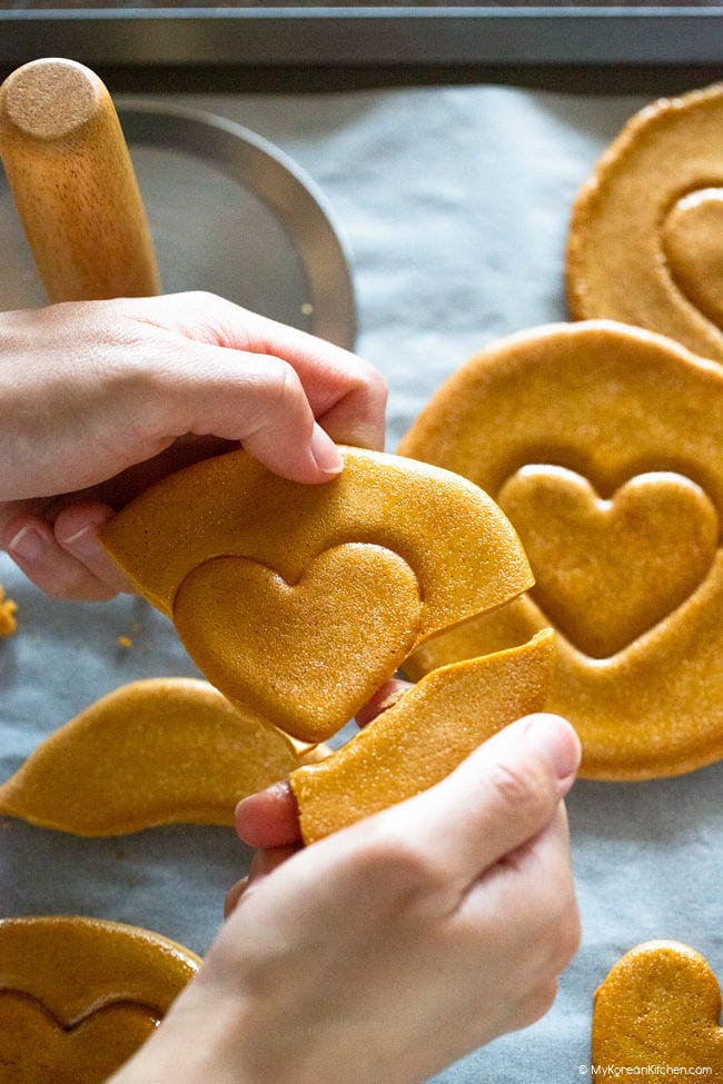 breaking dalgona around the heart shape
