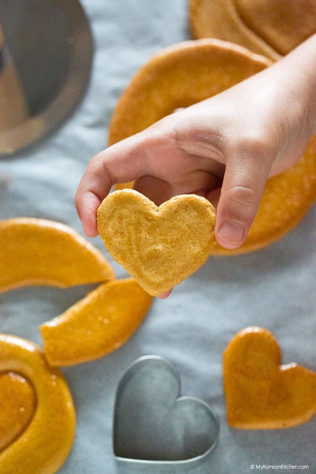 holding heart shaped dalgona