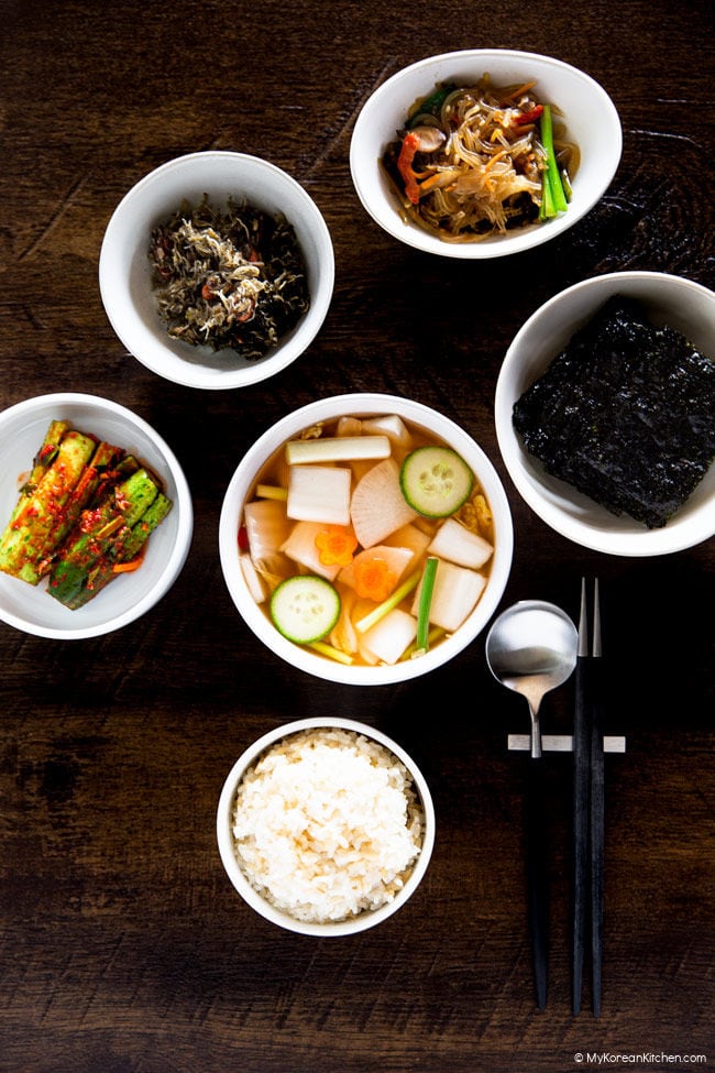 Nabak kimchi served alongside other Korean side dishes and a bowl of rice.