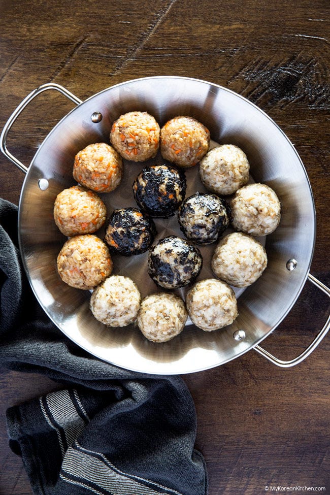 Rice balls served on a stainless steel tray.