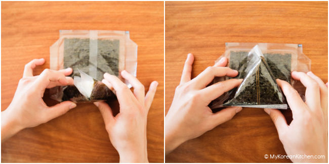 Folding down the seaweed at the top left and right corners to wrap around the triangle rice.